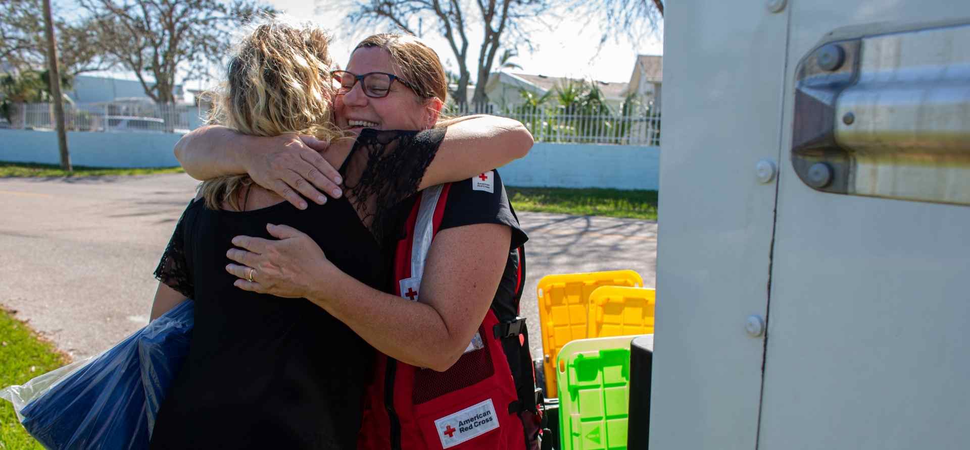 Red cross volunteer hugging a community member | Zoetis